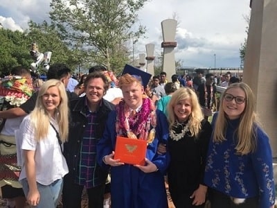 A picture of Michelle Larson with her husband and kids at Arthur's graduation.